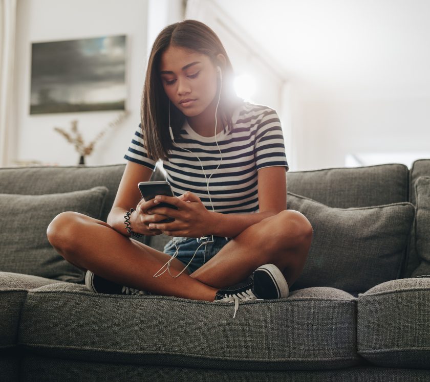 Resources 33 Girl listening to music sitting on couch