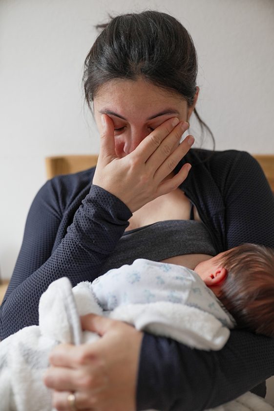 Resources 11 Mother breastfeeding her newborn, wiping tears away